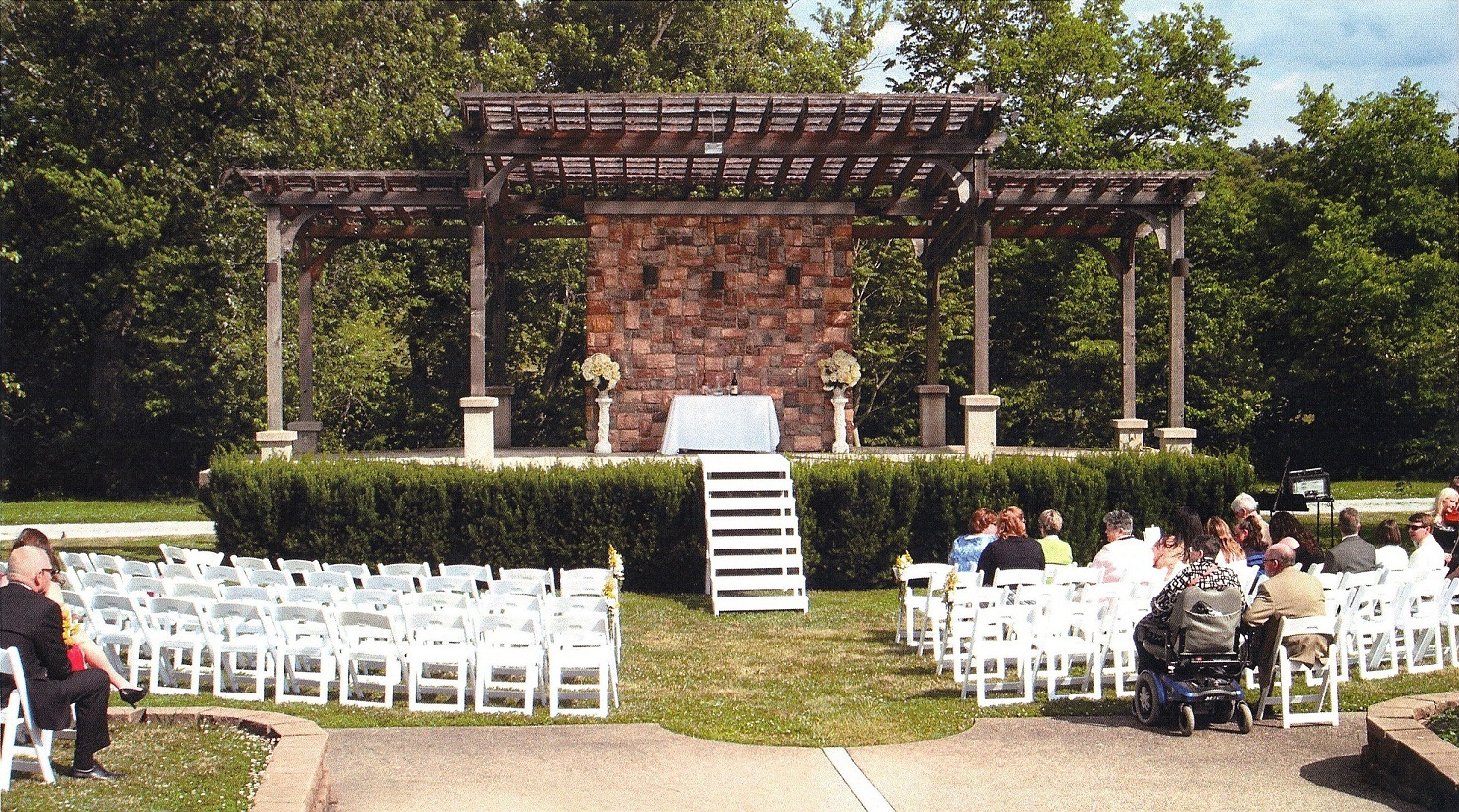An outdoor wedding ceremony set in a park